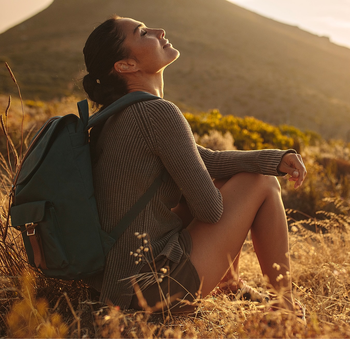 Woman enjoying nature during golden hour.