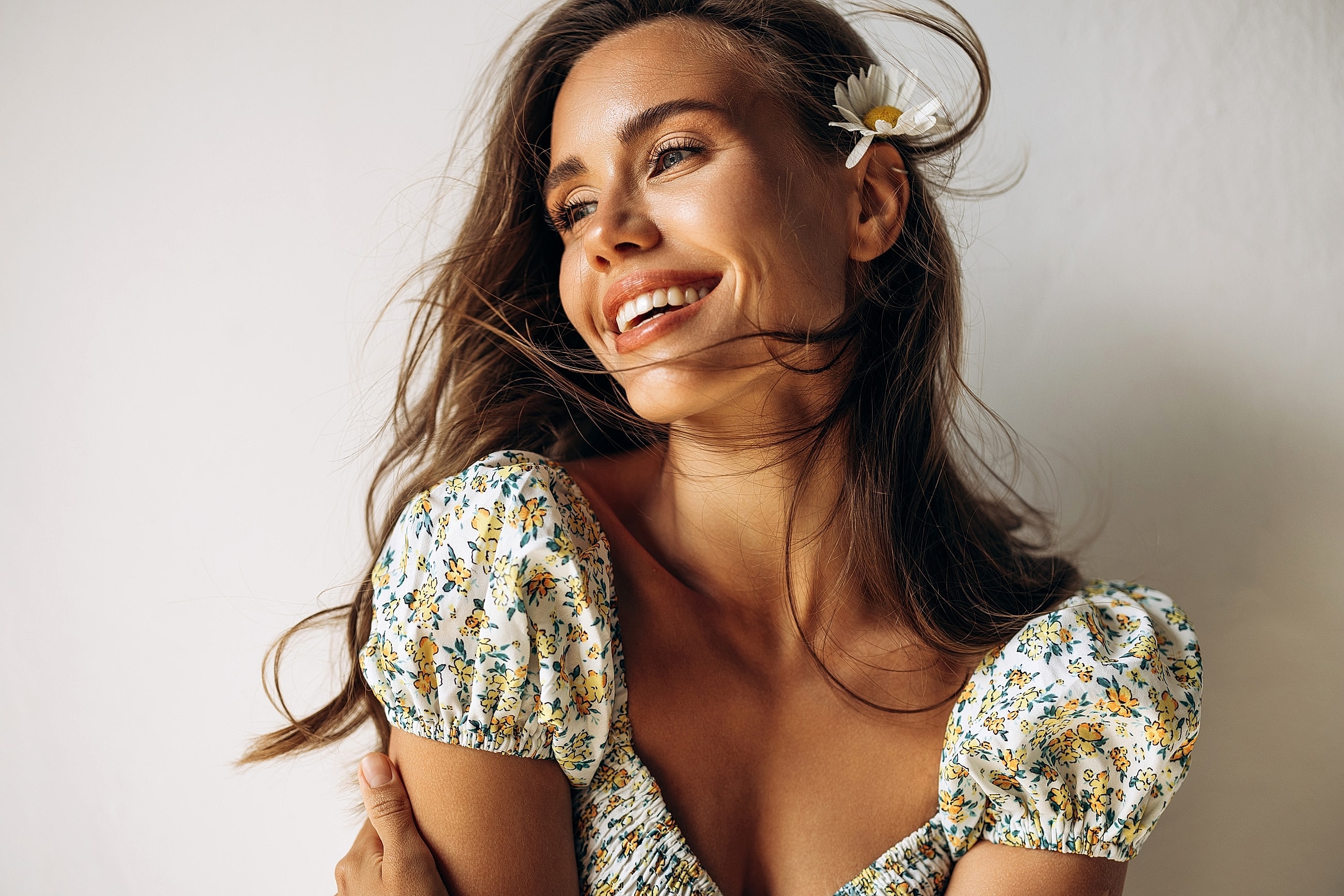 Smiling woman with flower in her hair.